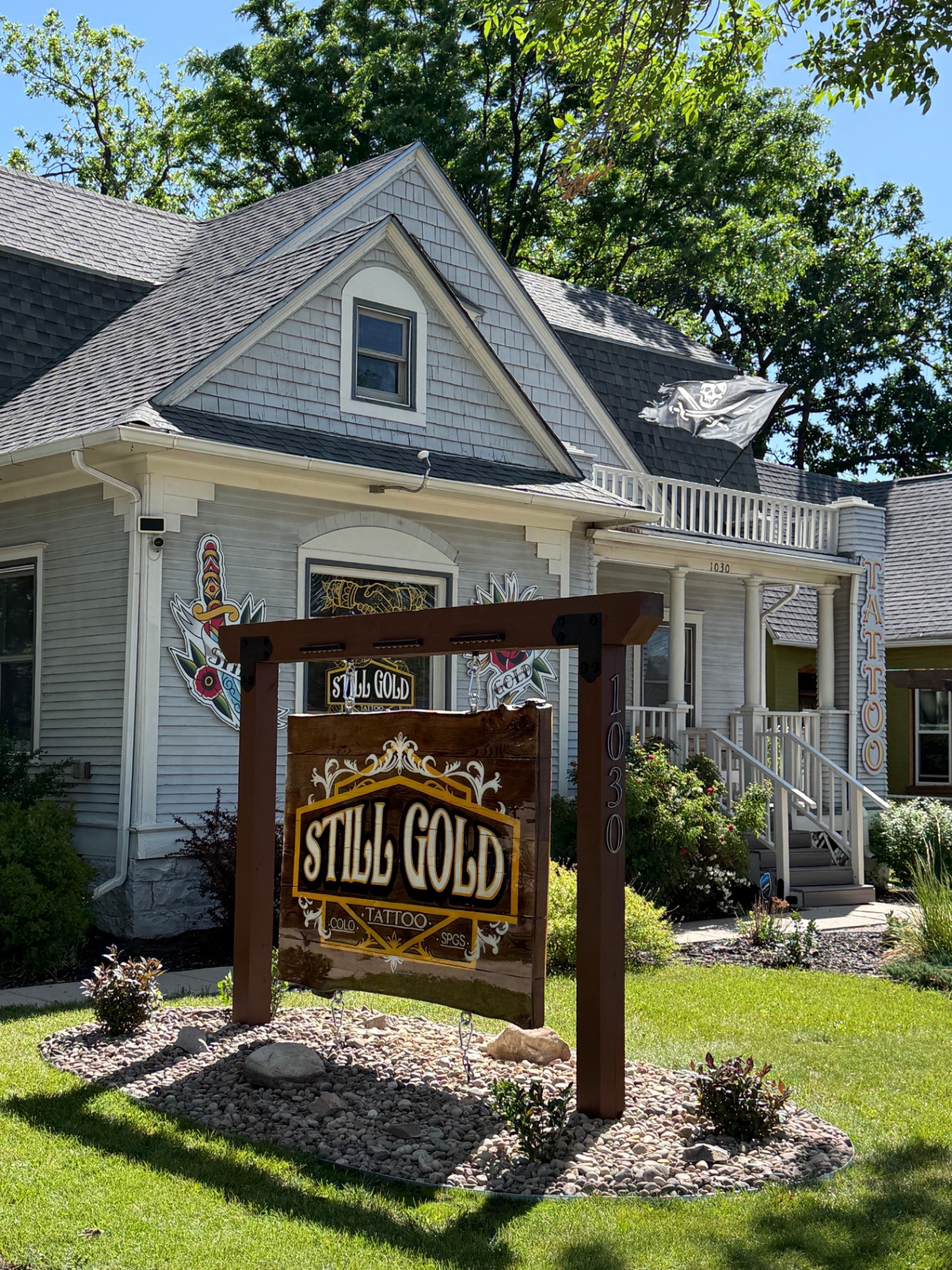 Still Gold Tattoo storefront sign and Victorian house exterior