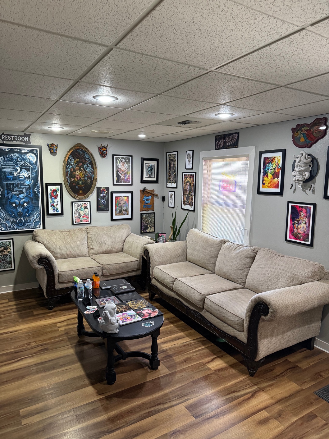 Still Gold Tattoo client lounge with white sofa
