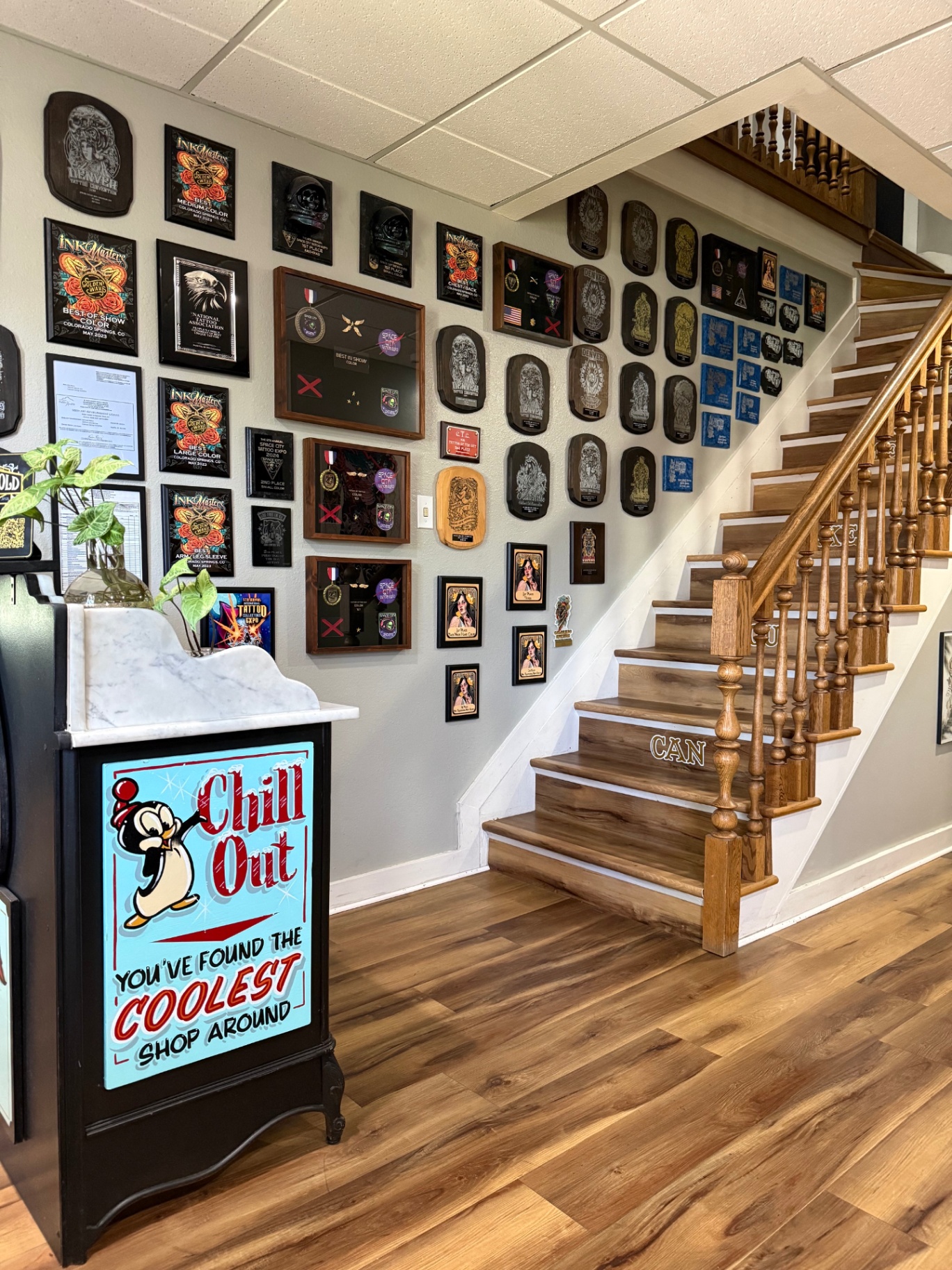 Entry hallway with award wall and staircase