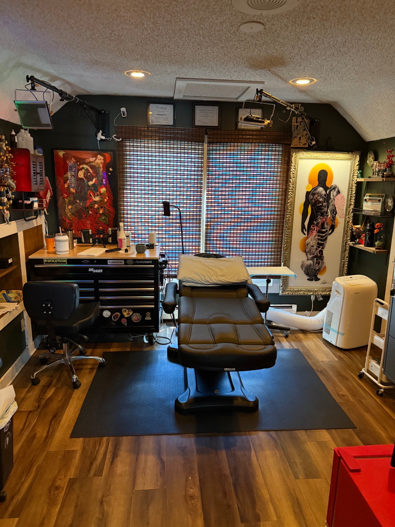 Private tattoo room with client chair and original artwork